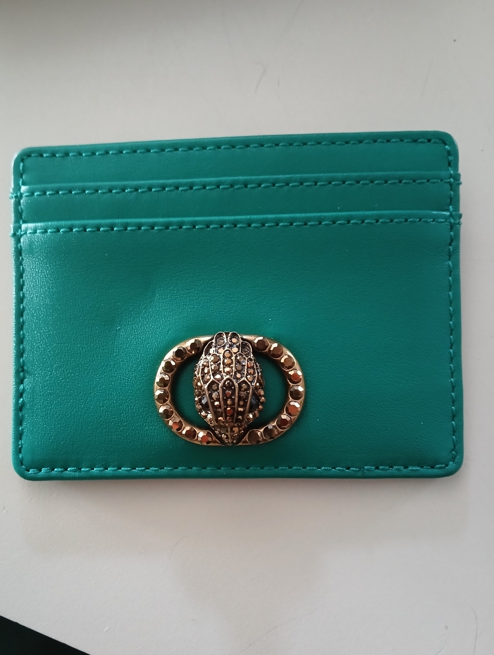 Kurt Geiger teal card holder with gold-tone beetle detail